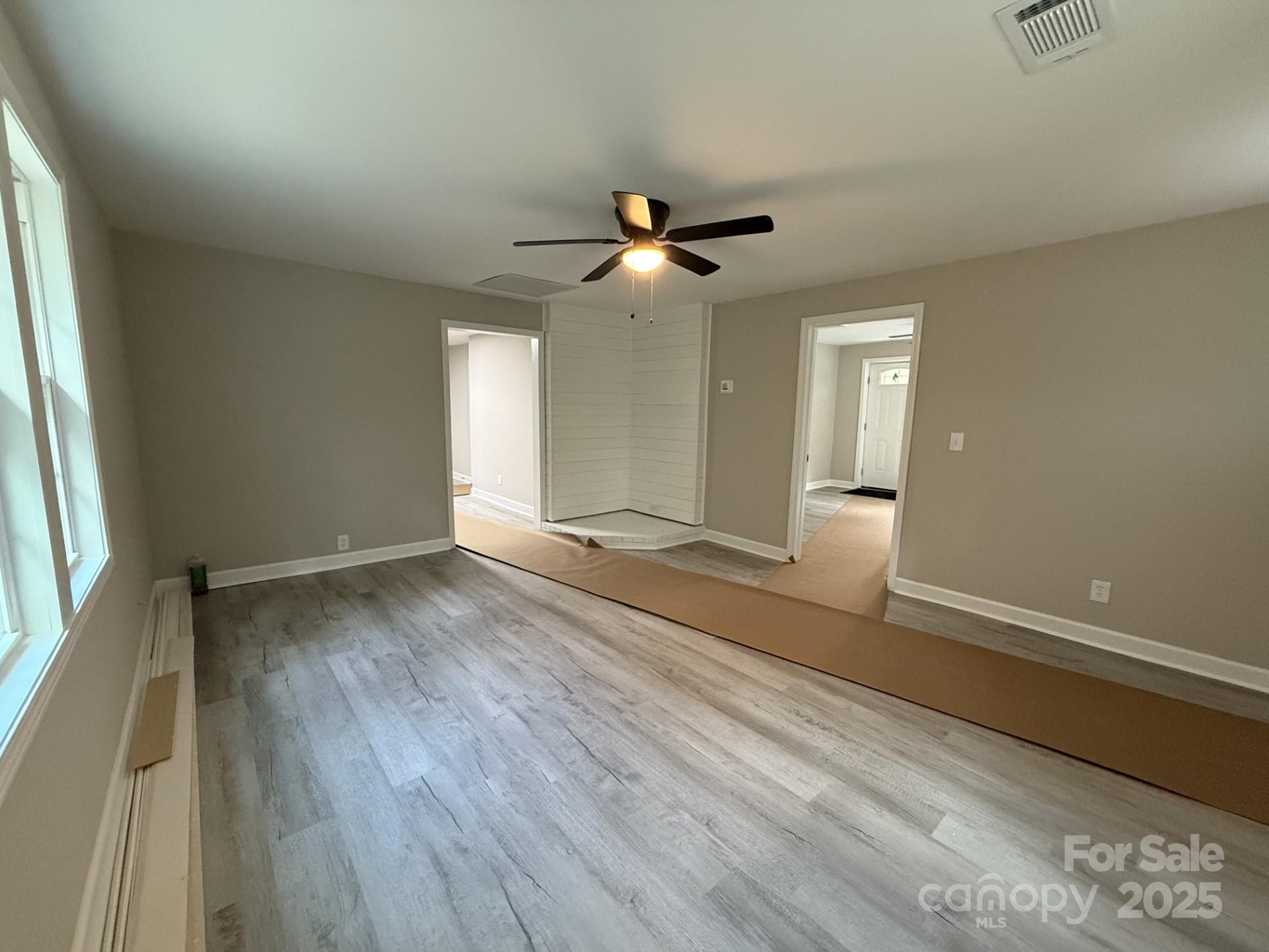 2791 State Rd S-29-285 Lancaster, SC 29720 - Photo 4 of 15 a view of empty room with wooden floor and fan