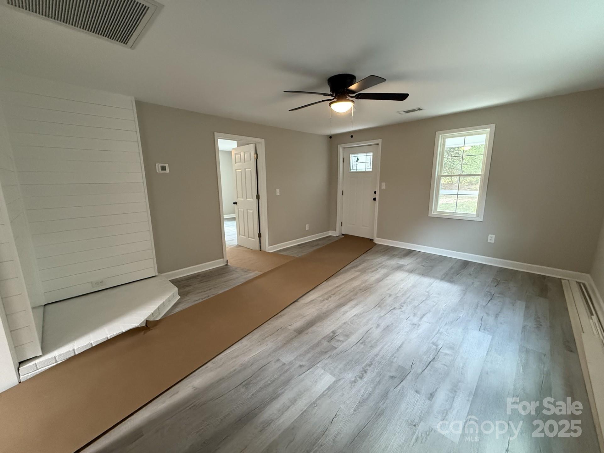 2791 State Rd S-29-285 Lancaster, SC 29720 - Photo 5 of 15 a view of an empty room with wooden floor and a window