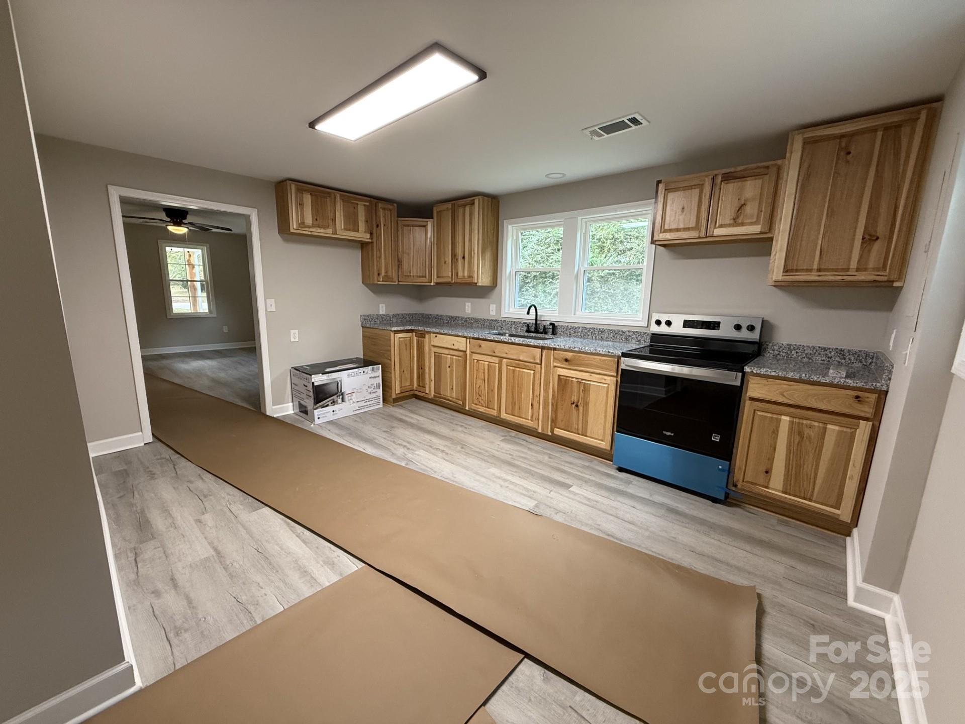 2791 State Rd S-29-285 Lancaster, SC 29720 - Photo 7 of 15 a kitchen with stainless steel appliances granite countertop a sink stove and refrigerator