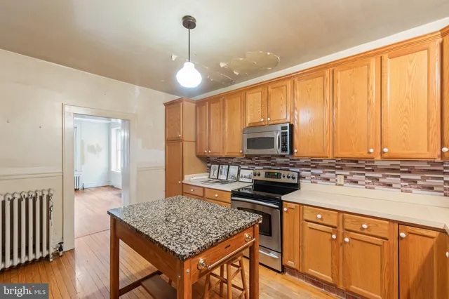 a kitchen with a stove a sink and a refrigerator