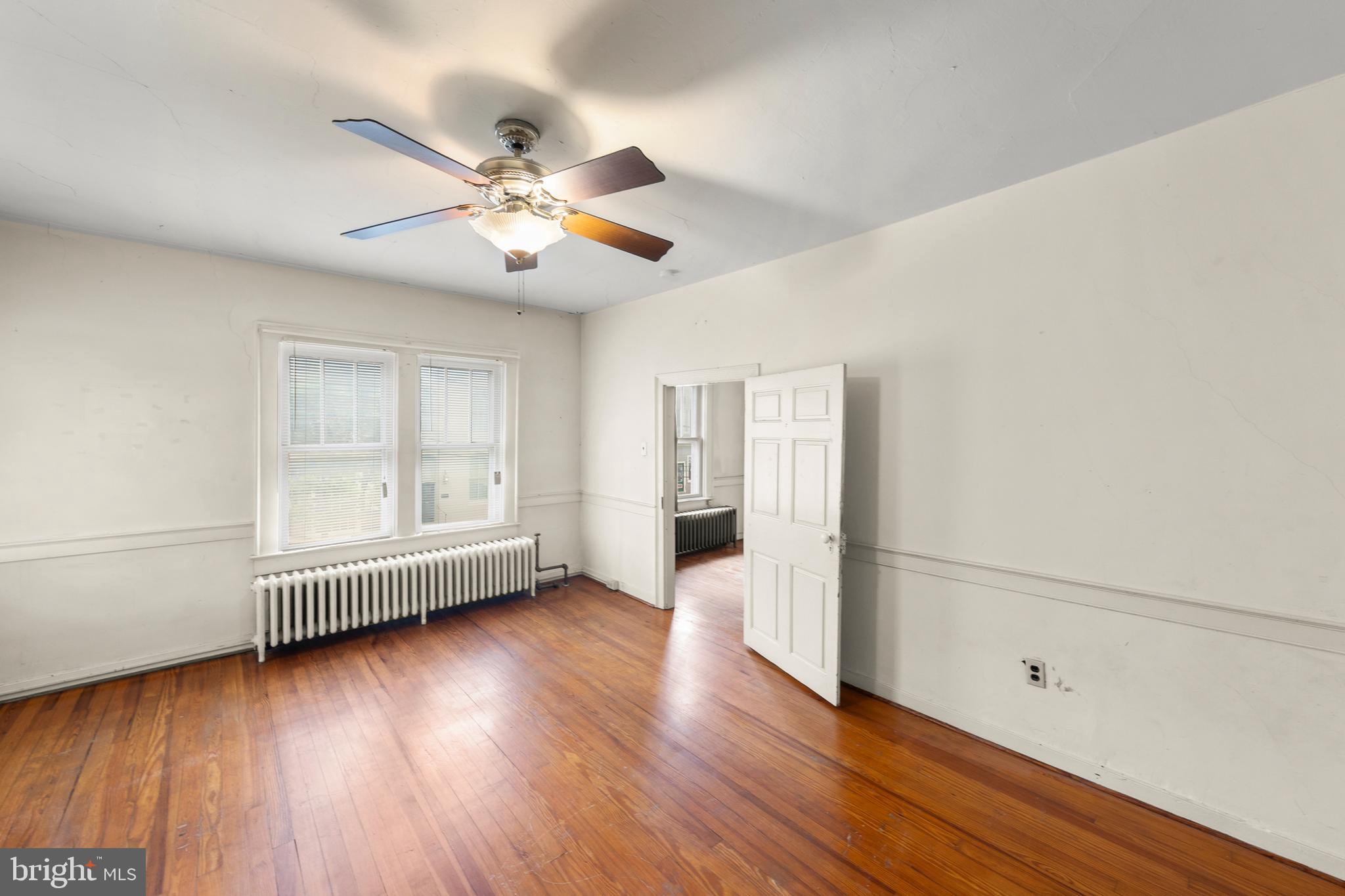 5342 Main Street Stephens City, VA 22655 - Photo 29 of 45 an empty room with wooden floor fan and windows
