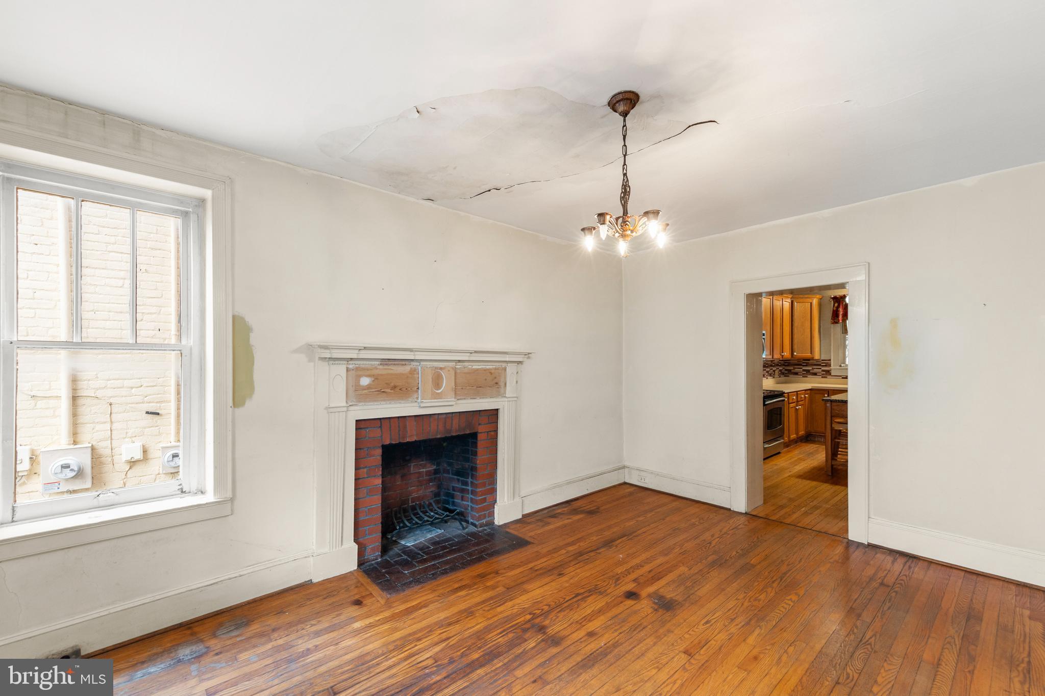 5342 Main Street Stephens City, VA 22655 - Photo 4 of 45 a view of an empty room with wooden floor fireplace and a window