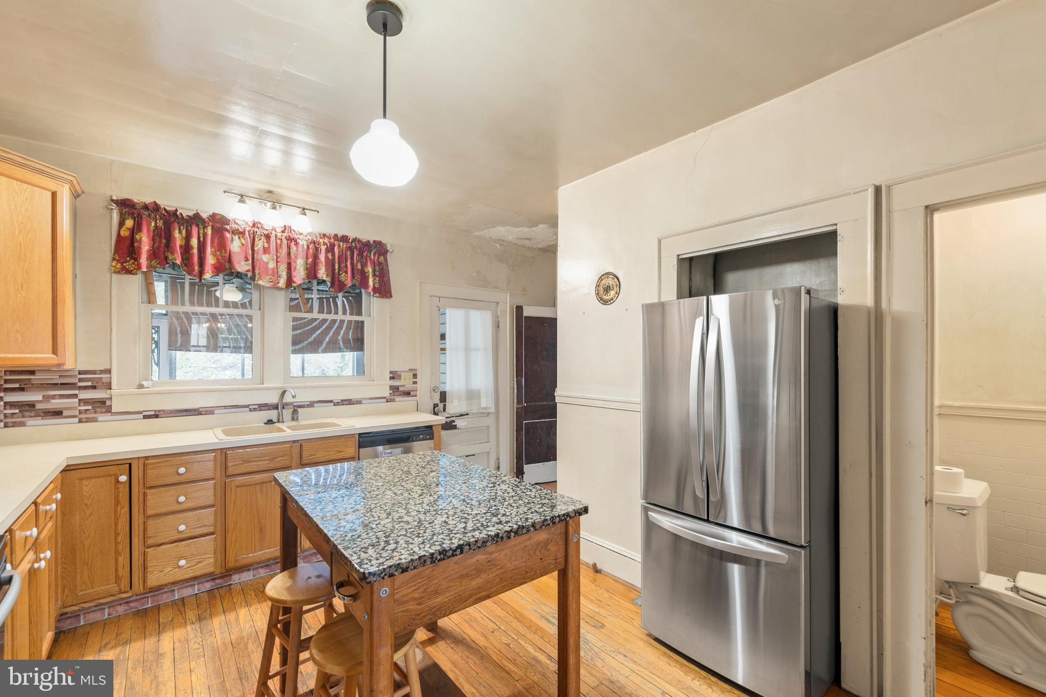 5342 Main Street Stephens City, VA 22655 - Photo 9 of 45 a kitchen with kitchen island a counter top space appliances and cabinets