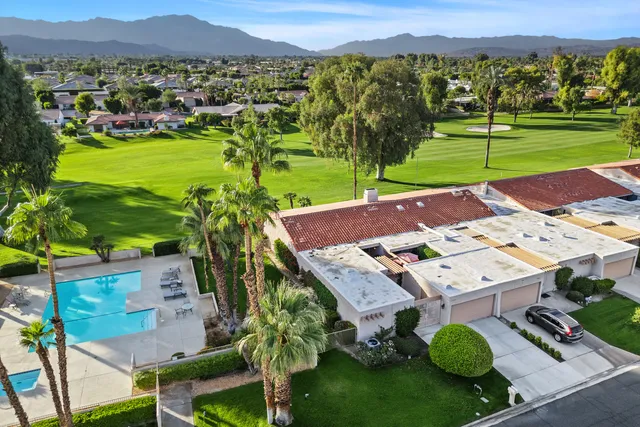 an aerial view of a house with a big yard