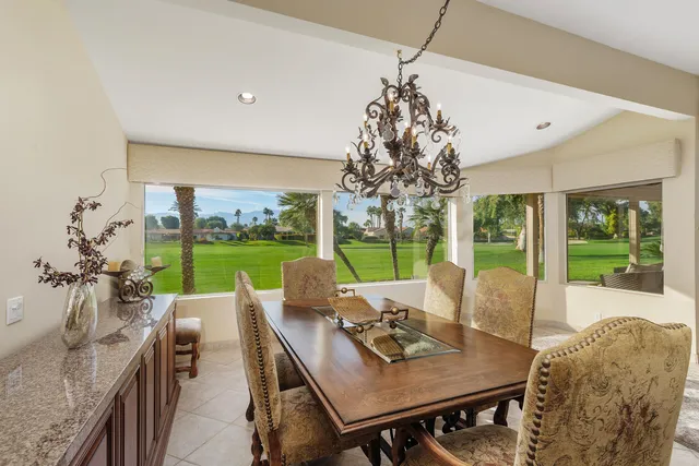 a view of a dining room with furniture and a chandelier