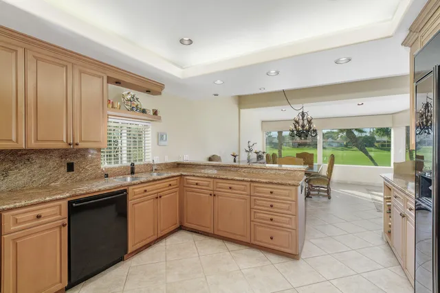 a open kitchen with a sink and dishwasher refrigerator stove