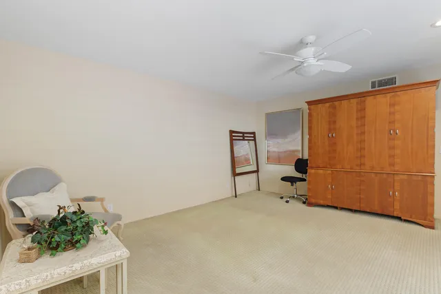 a view of a livingroom with furniture and a ceiling fan
