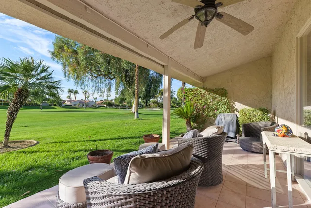 a view of a house with a backyard porch and sitting area