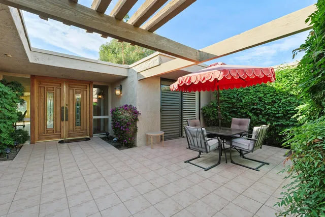 a patio with table and chairs
