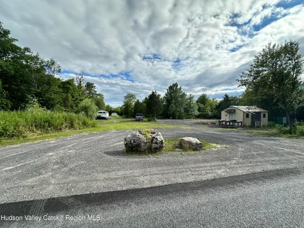 a view of a street with a cars parked