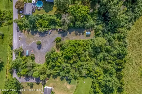 an aerial view of a house with a yard basket ball court and outdoor seating