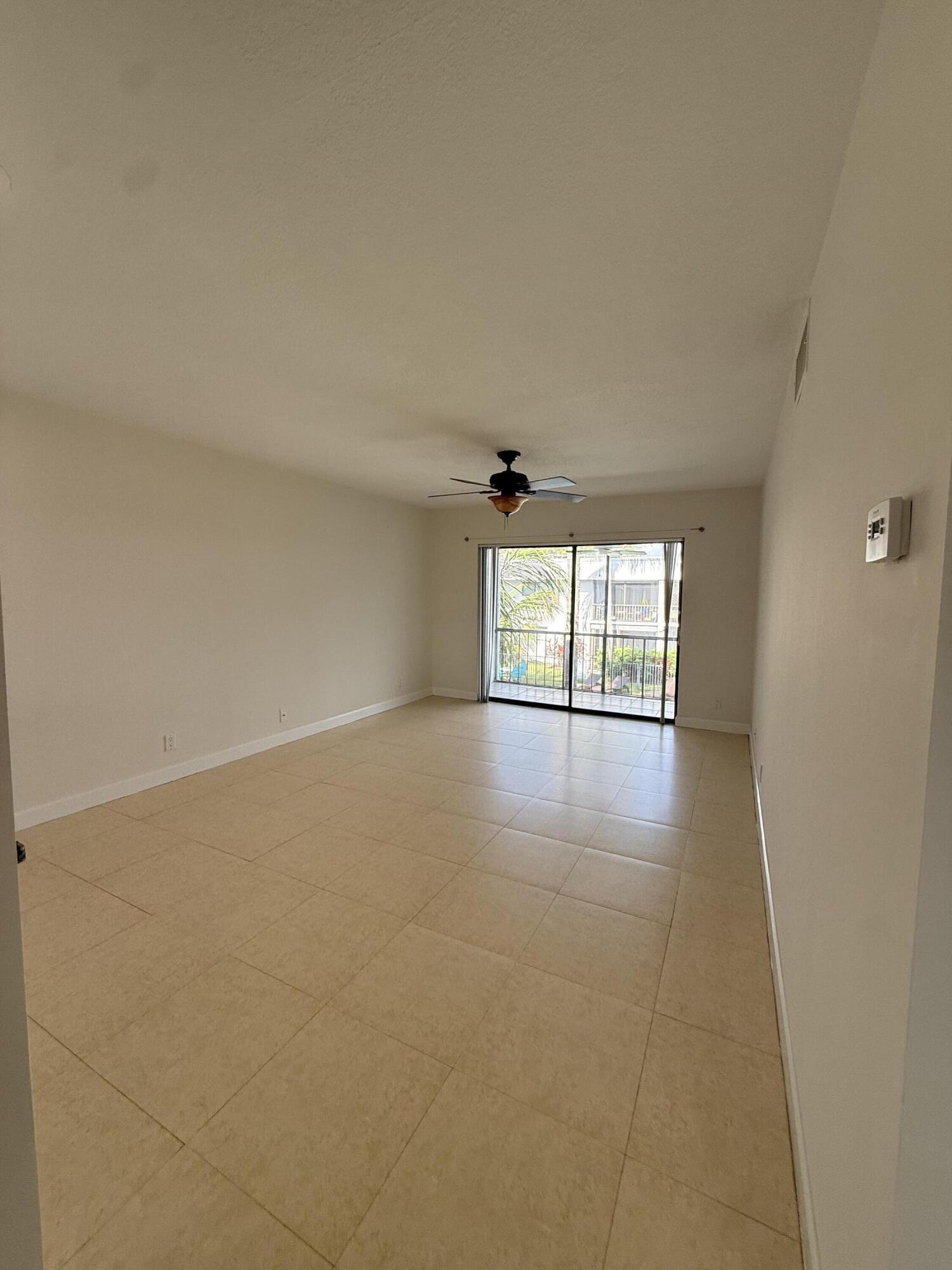 875 Northwest 13th Street, Unit 405 Boca Raton, FL 33486 - Photo 12 of 16 wooden floor in an empty room with a window