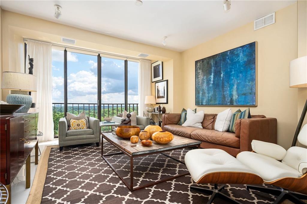 145 15th Street Northeast, Unit 1225 Atlanta, GA 30361 - Photo 1 of 54 a living room with furniture and a large window