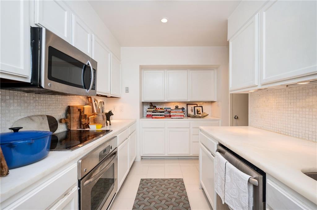 145 15th Street Northeast, Unit 1225 Atlanta, GA 30361 - Photo 11 of 54 a kitchen with a sink and a stove top oven