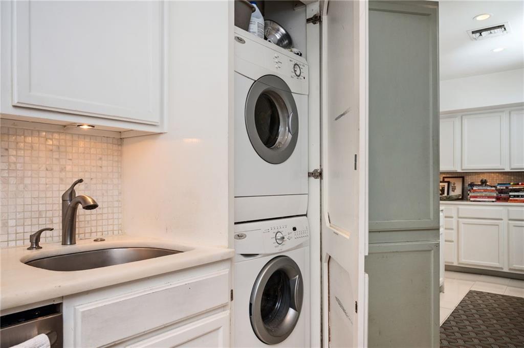 145 15th Street Northeast, Unit 1225 Atlanta, GA 30361 - Photo 13 of 54 a kitchen with a sink and a washer dryer