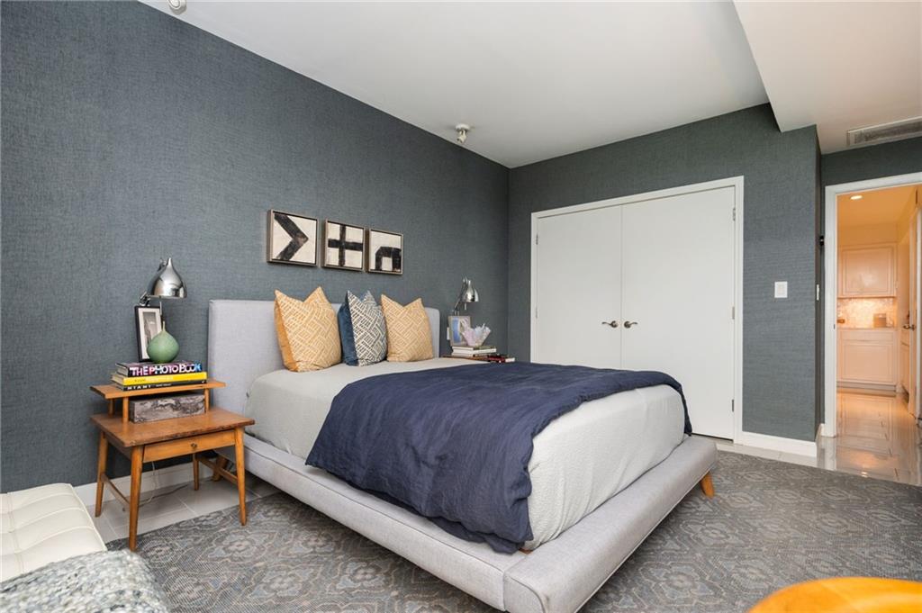 145 15th Street Northeast, Unit 1225 Atlanta, GA 30361 - Photo 16 of 54 a spacious bedroom with a bed and a couch