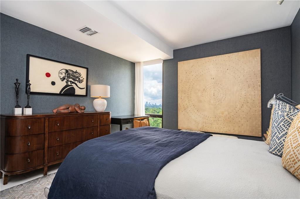 145 15th Street Northeast, Unit 1225 Atlanta, GA 30361 - Photo 17 of 54 a bedroom with a bed and a flat screen tv