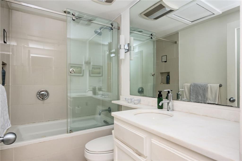 145 15th Street Northeast, Unit 1225 Atlanta, GA 30361 - Photo 19 of 54 a bathroom with a sink a toilet and shower