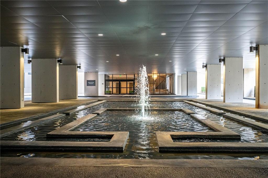 145 15th Street Northeast, Unit 1225 Atlanta, GA 30361 - Photo 23 of 54 a kitchen with stainless steel appliances granite countertop a stove and white cabinets