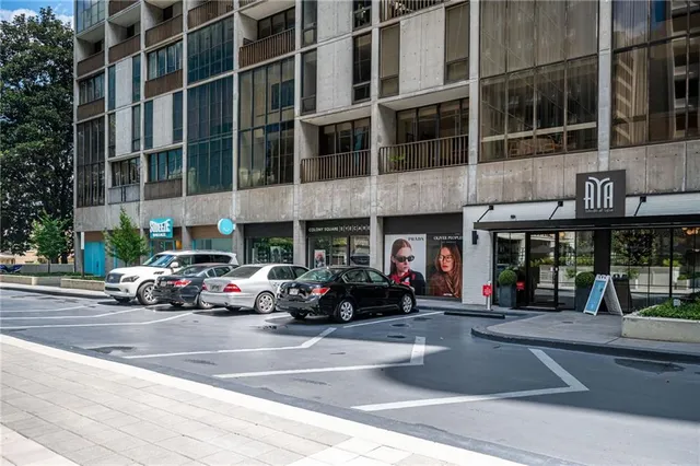 a view of a street with large trees