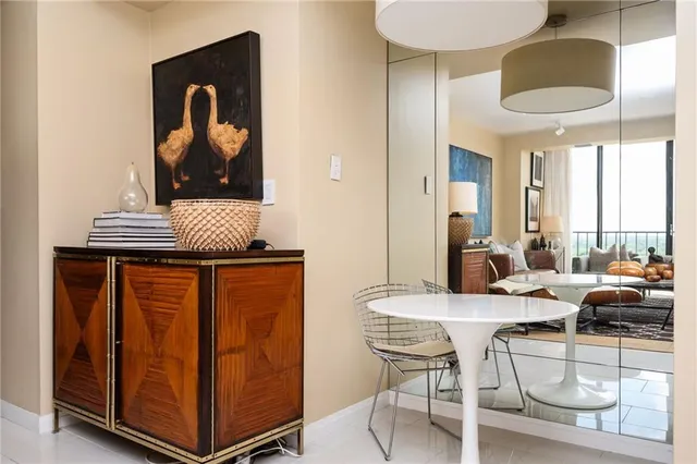 a dining room with furniture and a window
