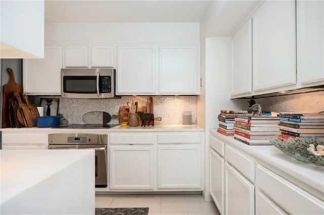 a kitchen with stainless steel appliances granite countertop a sink stove and cabinets