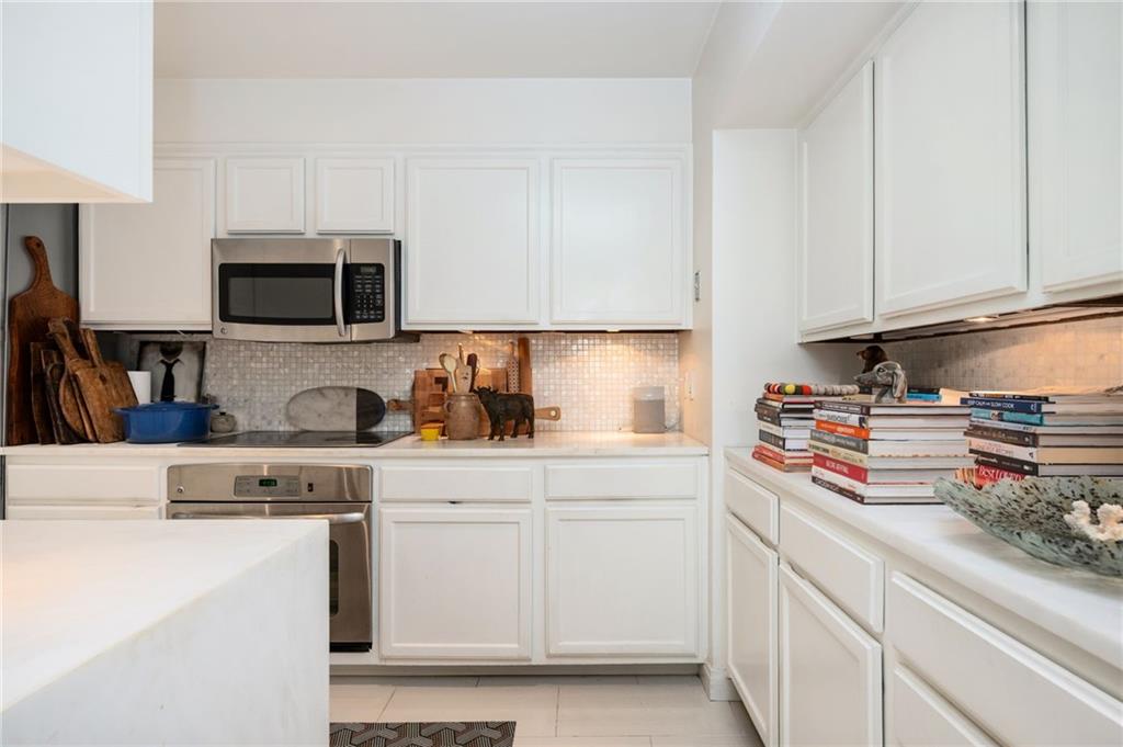 145 15th Street Northeast, Unit 1225 Atlanta, GA 30361 - Photo 9 of 54 a kitchen with stainless steel appliances granite countertop a sink stove and cabinets