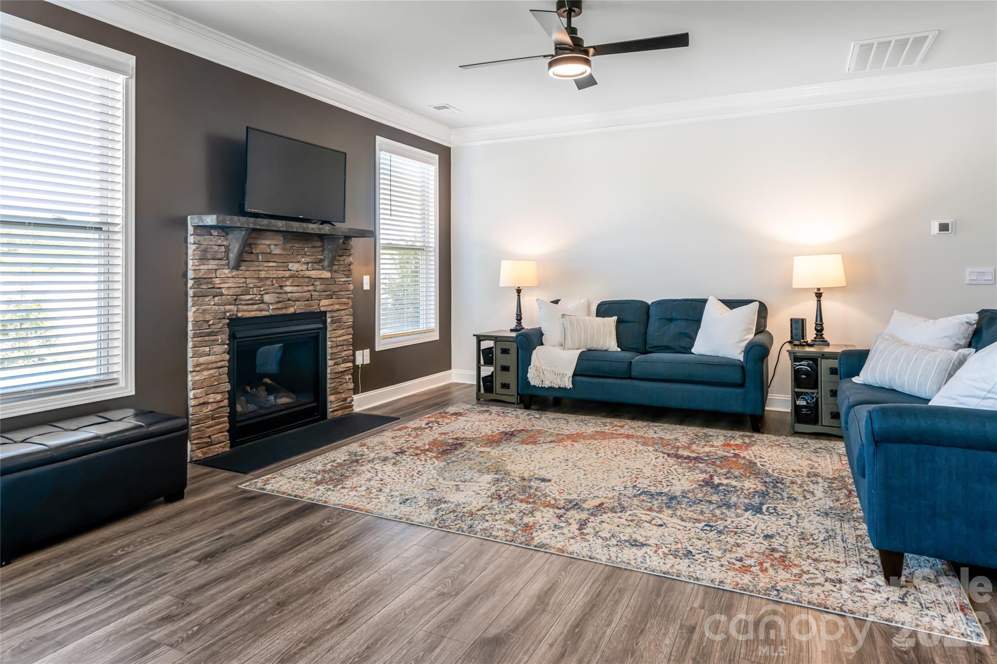 615 Fox Cove Road Hendersonville, NC 28792 - Photo 13 of 47 a living room with furniture flat screen tv and a fireplace