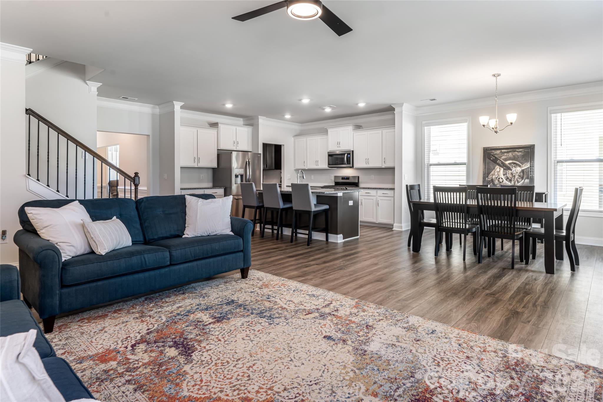 615 Fox Cove Road Hendersonville, NC 28792 - Photo 15 of 47 a living room kitchen with a dining table wooden floor and a kitchen view