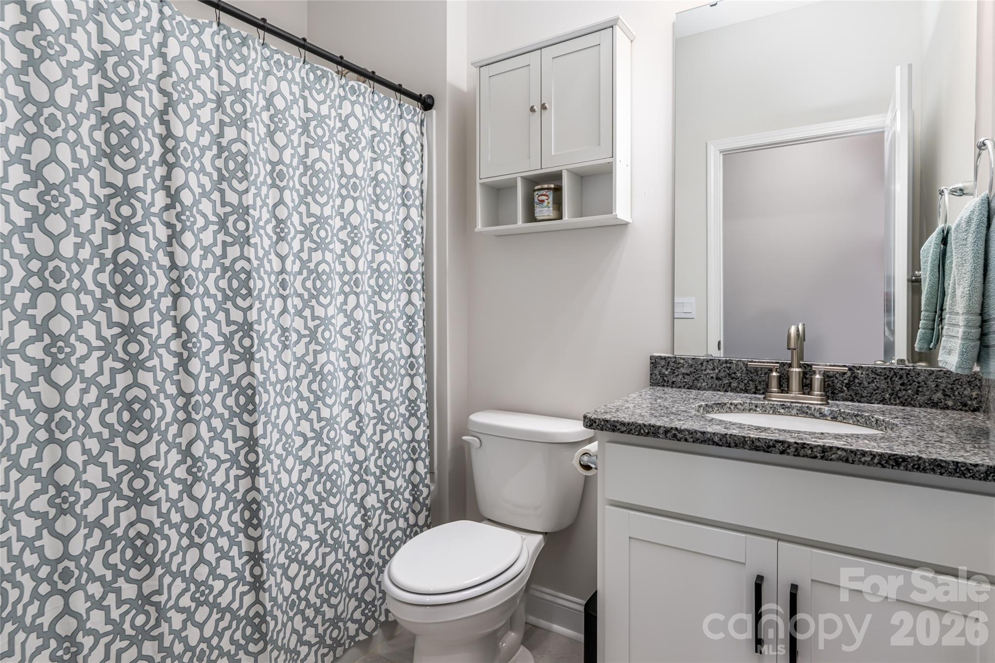 615 Fox Cove Road Hendersonville, NC 28792 - Photo 35 of 47 a bathroom with a granite countertop toilet and a sink