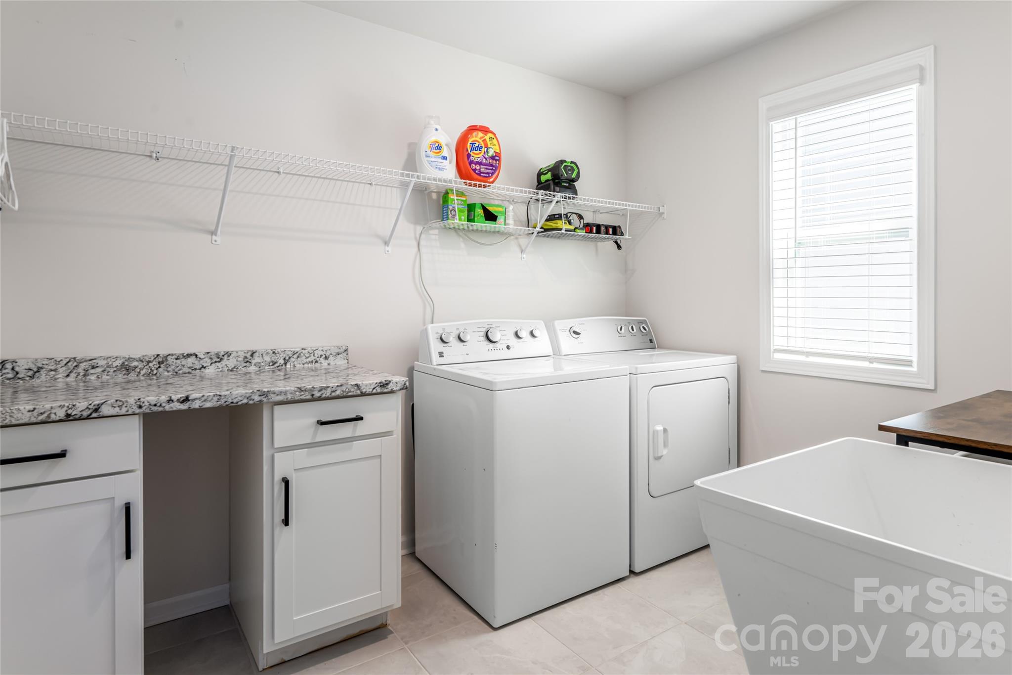 615 Fox Cove Road Hendersonville, NC 28792 - Photo 39 of 47 a utility room with dryer washer and a window