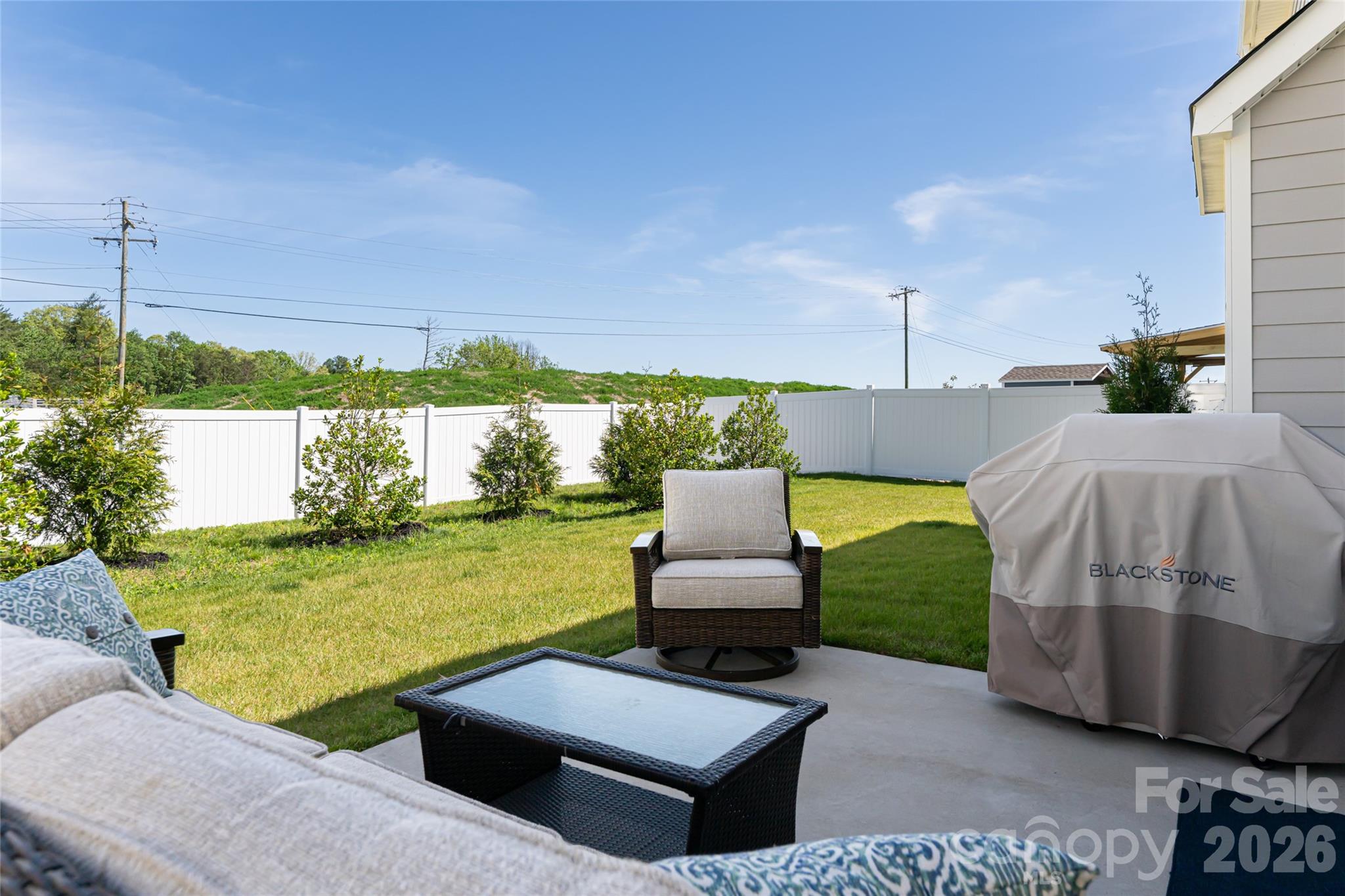 615 Fox Cove Road Hendersonville, NC 28792 - Photo 5 of 47 a view of a patio with lawn chairs floor to ceiling window and yard
