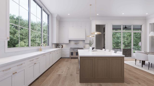 a large kitchen with kitchen island a large window a sink and stainless steel appliances