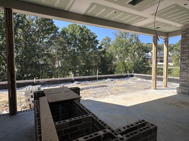 a view of a patio with table and chairs with wooden floor and fence