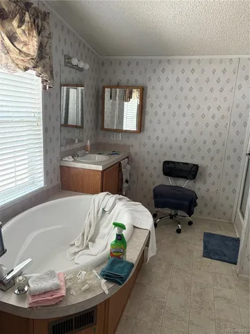 a bath tub sitting in a bathroom next to a sink