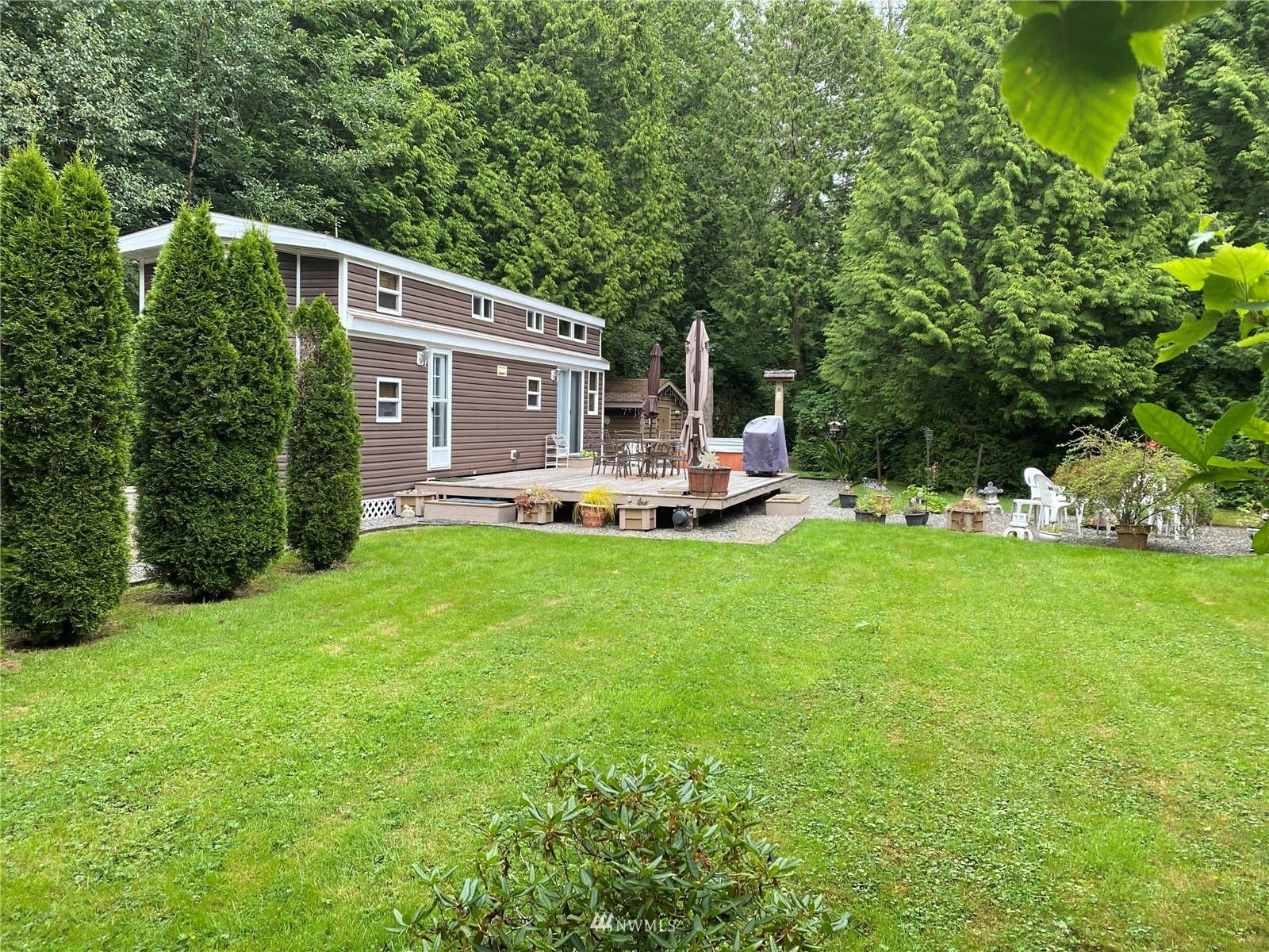 7888 Carson Road Blaine, WA 98230 - Photo 1 of 11 a front view of a house with garden and trees