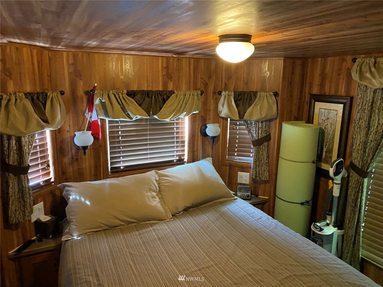7888 Carson Road Blaine, WA 98230 - Photo 6 of 11 a bedroom with a bed and a chandelier