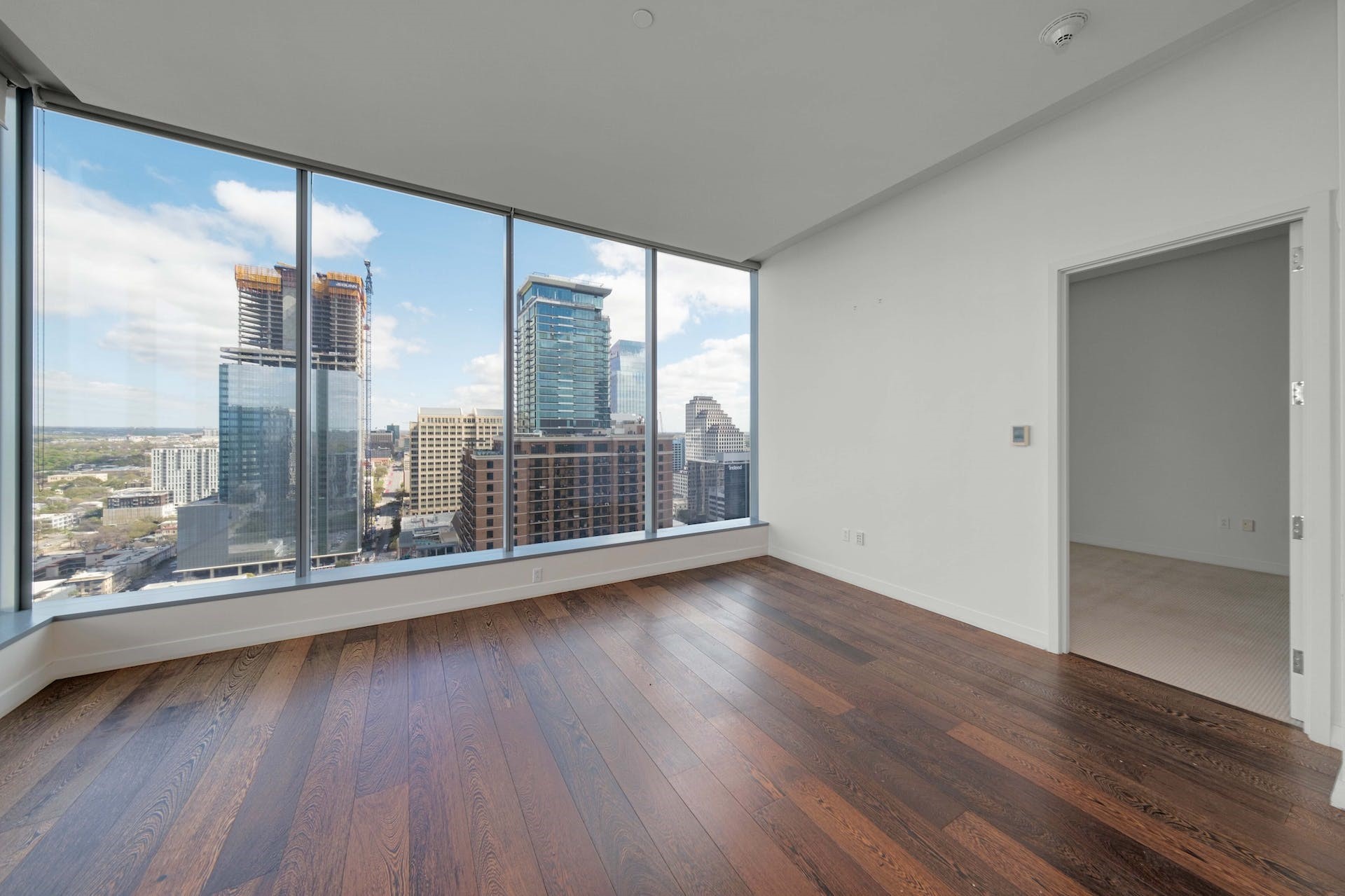 210 Lavaca Street, Unit 2608 Austin, TX 78701 - Photo 12 of 40 an empty room with wooden floor and windows