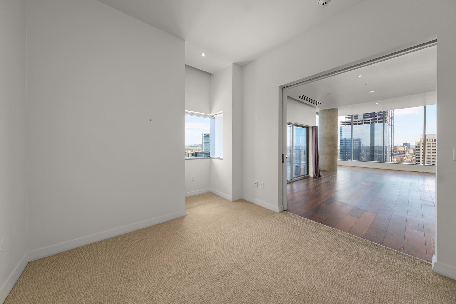 210 Lavaca Street, Unit 2608 Austin, TX 78701 - Photo 21 of 40 a view of a hallway with wooden floor and a living room