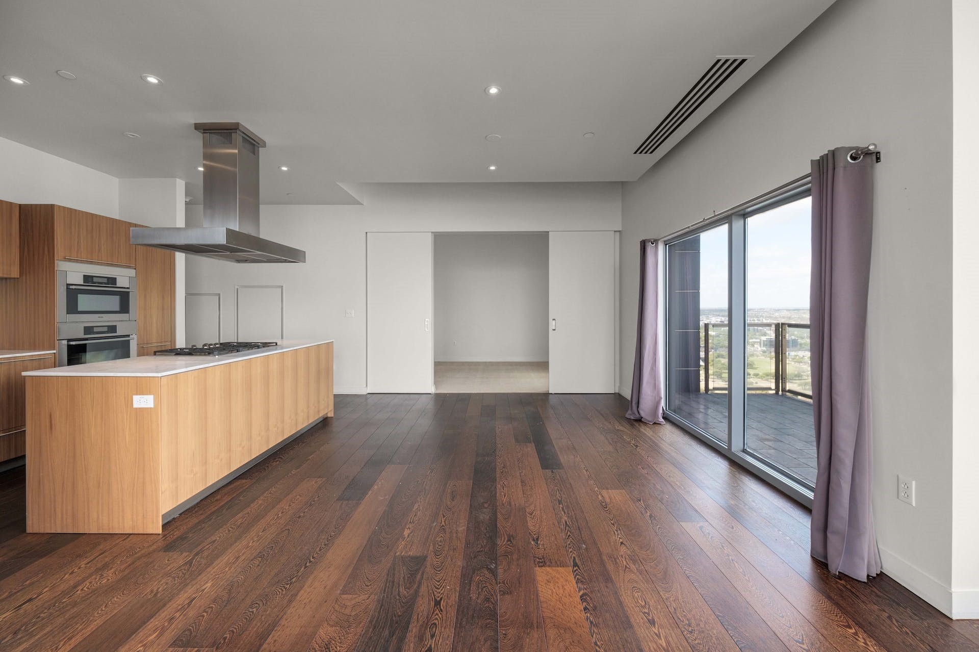 210 Lavaca Street, Unit 2608 Austin, TX 78701 - Photo 8 of 40 a room with wooden floors and windows