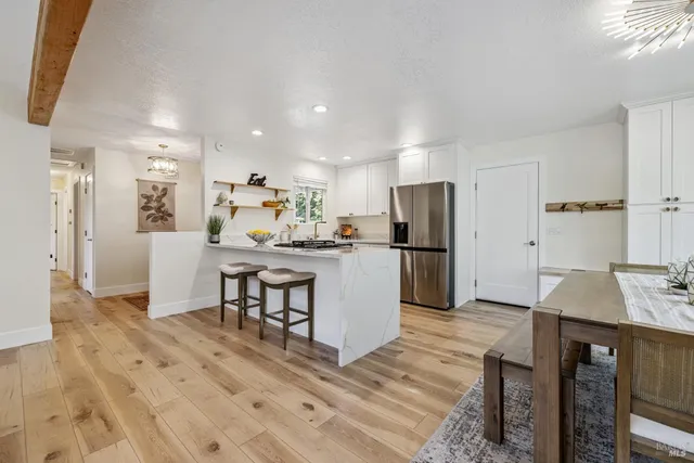 a kitchen with stainless steel appliances granite countertop a sink and a refrigerator