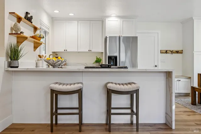 a kitchen with a refrigerator and a stove