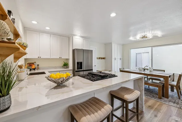 a kitchen with stainless steel appliances a refrigerator sink and stove