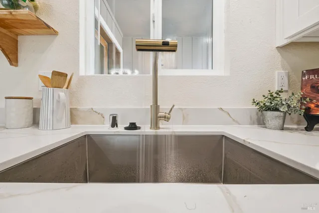 a living room with a table chairs and a wooden floor