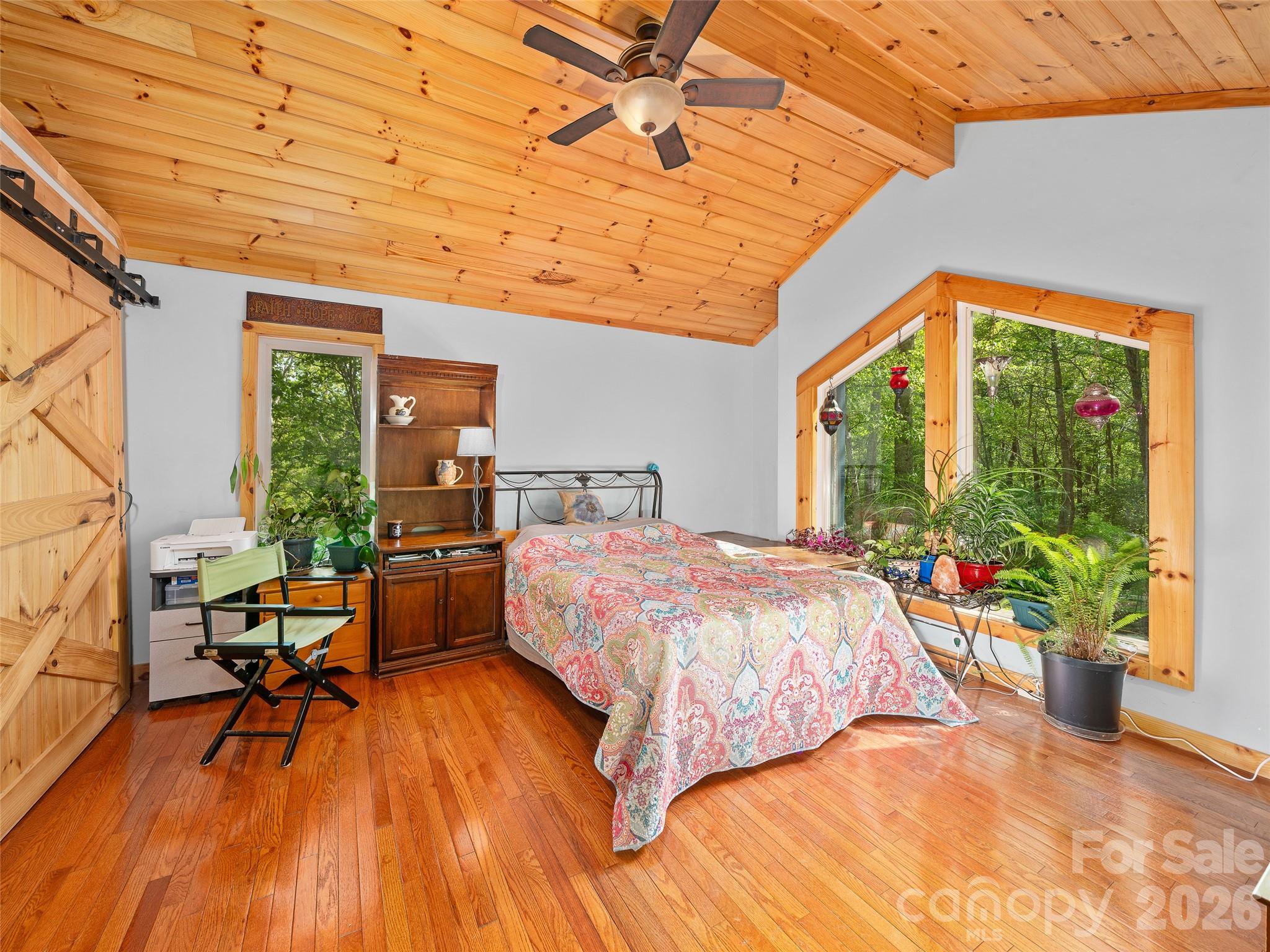 228 Continental Divide Road Spruce Pine, NC 28777 - Photo 13 of 48 a bed sitting in a bedroom next to a window