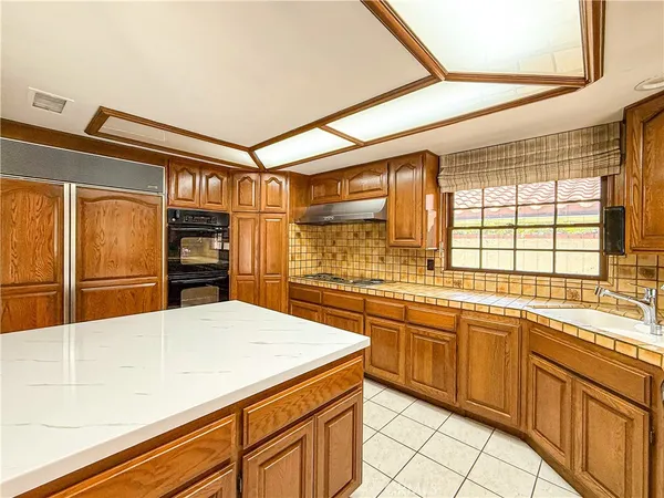 a kitchen with stainless steel appliances kitchen island granite countertop a sink and cabinets