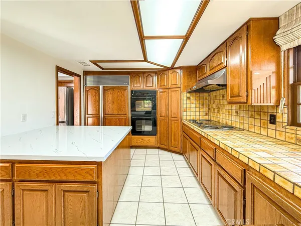 a view of a bathroom with stainless steel appliances granite countertop a sink and cabinets