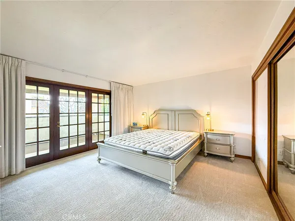 a spacious bedroom with a bed and a window