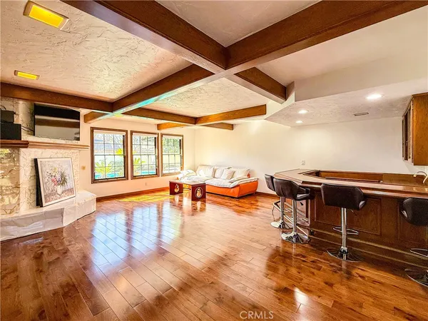 a living room with furniture a rug and a floor to ceiling window
