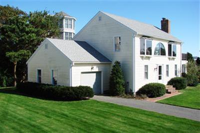 92 Harbor Road Hyannis, MA 02601 - Photo 17 of 22 a view of a white house next to a yard with potted plants